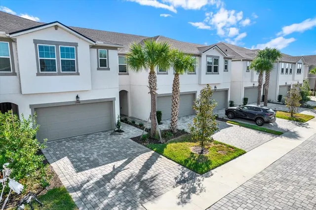 a view of a house with backyard and sitting area