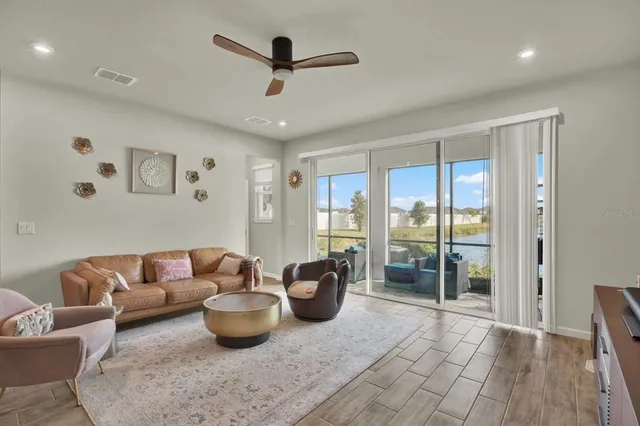 a living room with furniture and a floor to ceiling window