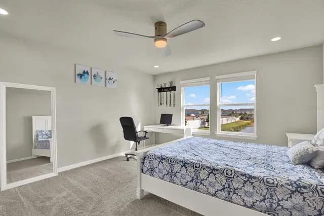 a bedroom with a large bed and a large window