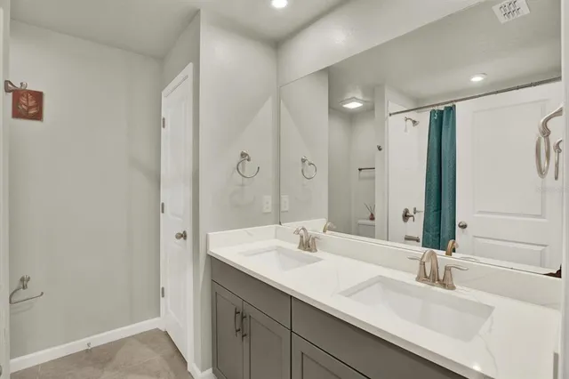 a bathroom with a double vanity sink mirror and double