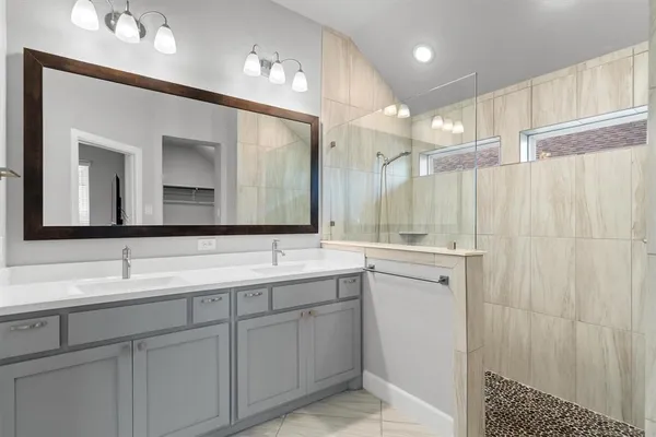 a bathroom with a double vanity sink mirror and double