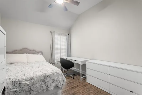 a bedroom with a bed and a table in it