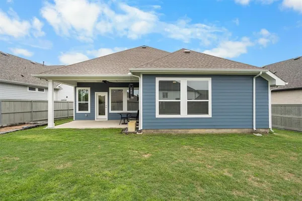 a front view of a house with a garden and yard
