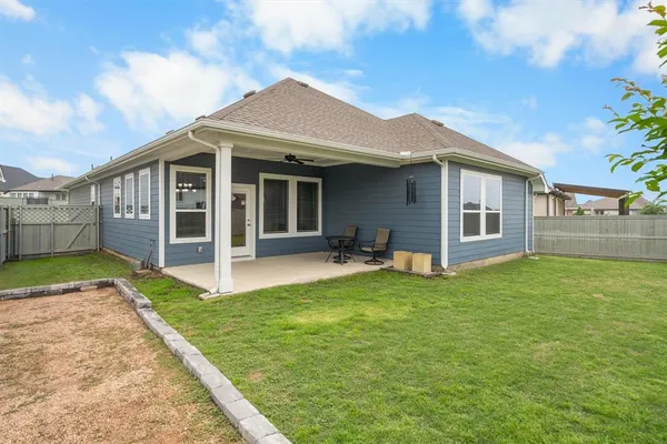 a view of a house with a yard and sitting area