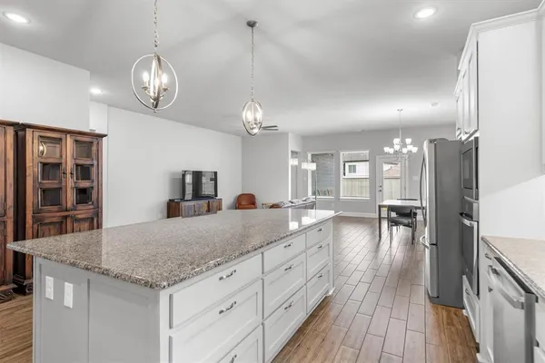 a view of living room and kitchen with wooden floor