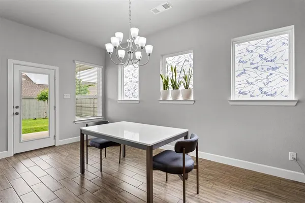 a view of a dining room with furniture and chandelier