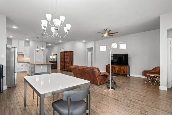 a view of a dining room with furniture and wooden floor