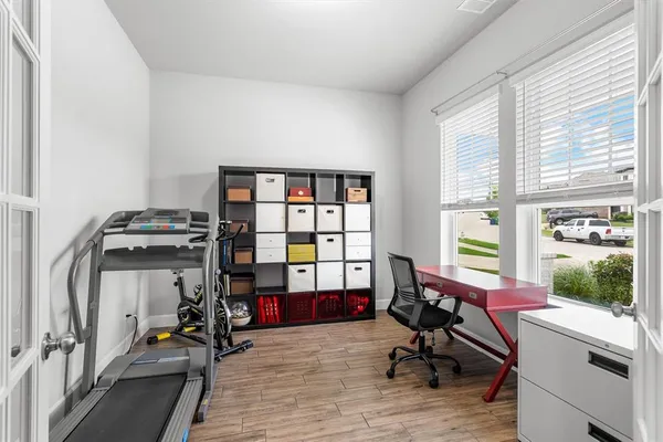 a view of a workspace with furniture and a window