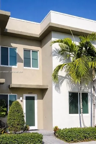 a view of a house with a potted plant and a window