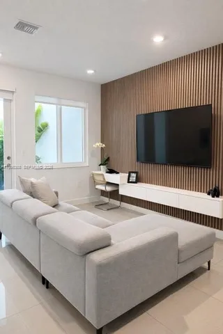 a living room with a couch and a flat screen tv