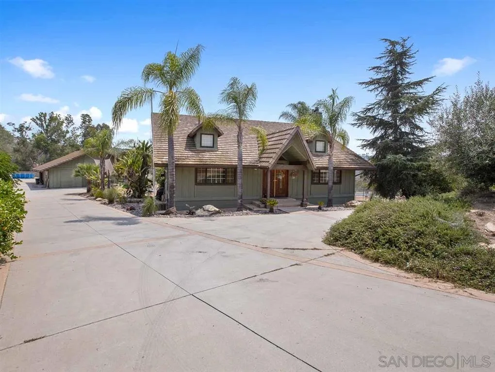 30527 Andreen Road Valley Center, CA 92082 - Photo 3 of 25 a front view of a house with a yard and garage