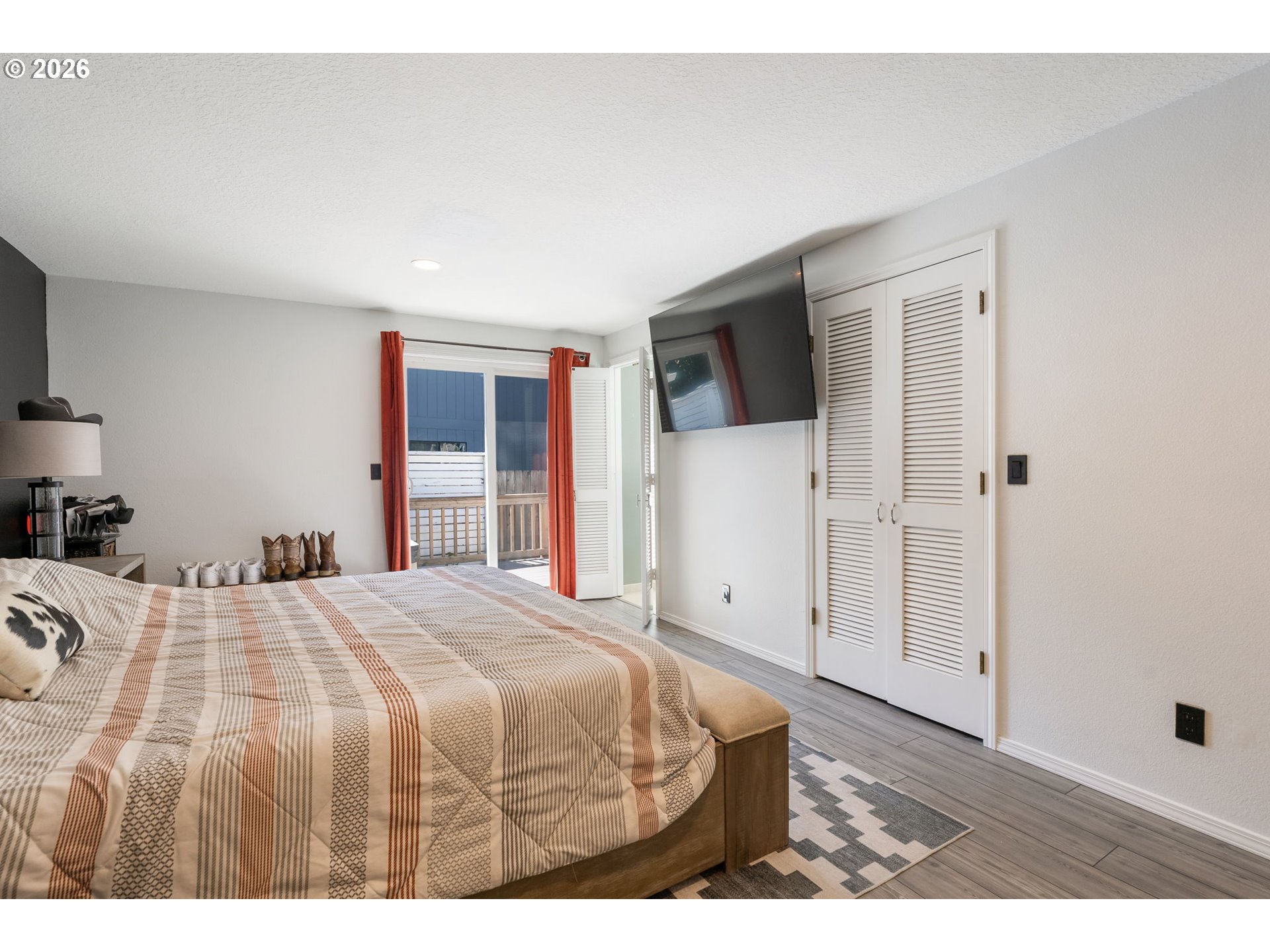 14877 Southwest Oregon Trail Lane Beaverton, OR 97006 - Photo 15 of 41 a bedroom with a bed and a flat screen tv