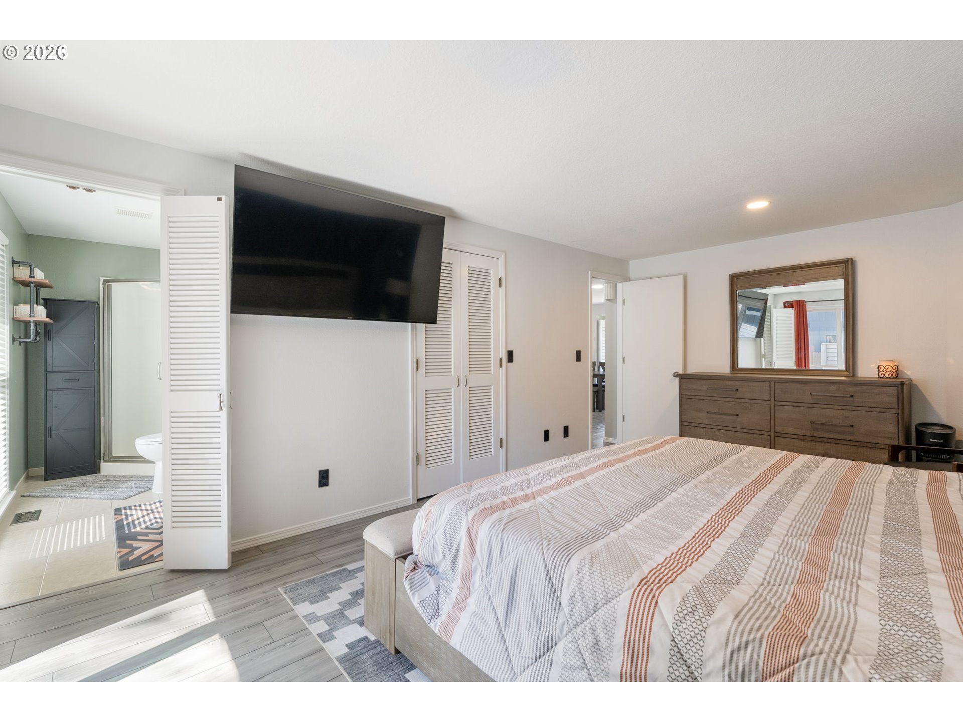 14877 Southwest Oregon Trail Lane Beaverton, OR 97006 - Photo 16 of 41 a spacious bedroom with a bed and a flat screen tv