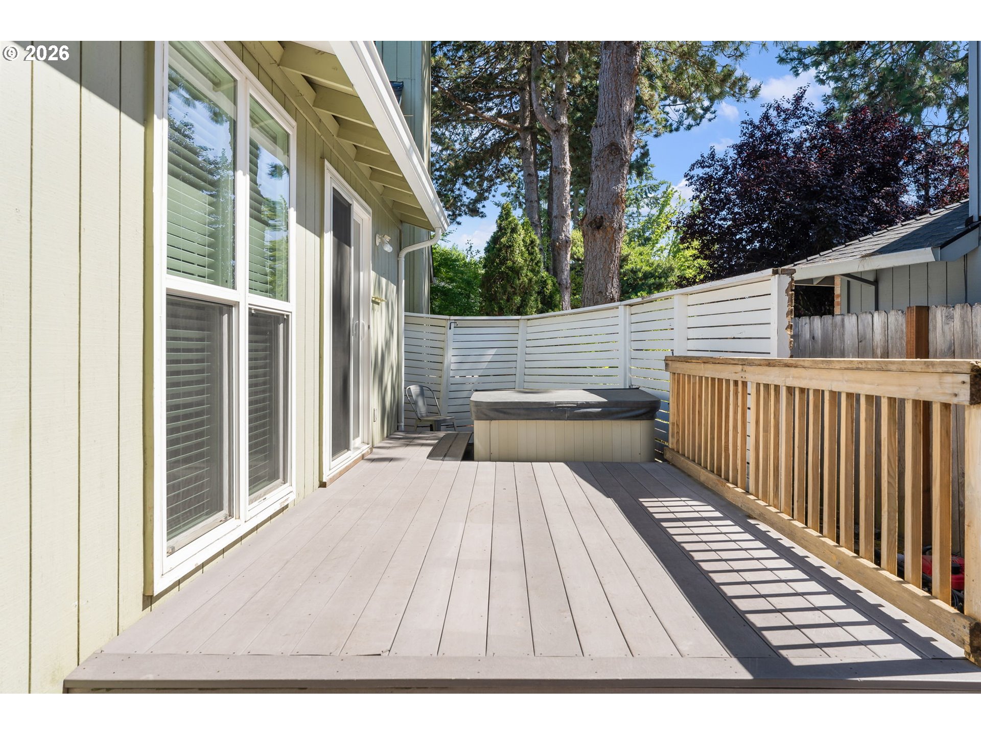 14877 Southwest Oregon Trail Lane Beaverton, OR 97006 - Photo 19 of 41 a view of a patio with table and chairs with wooden floor and fence