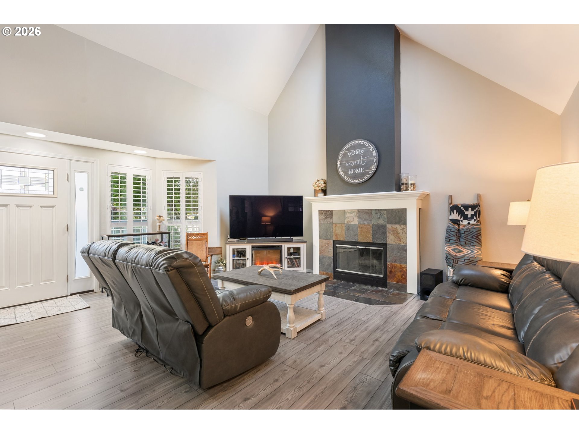 14877 Southwest Oregon Trail Lane Beaverton, OR 97006 - Photo 2 of 41 a living room with furniture a flat screen tv and a fireplace