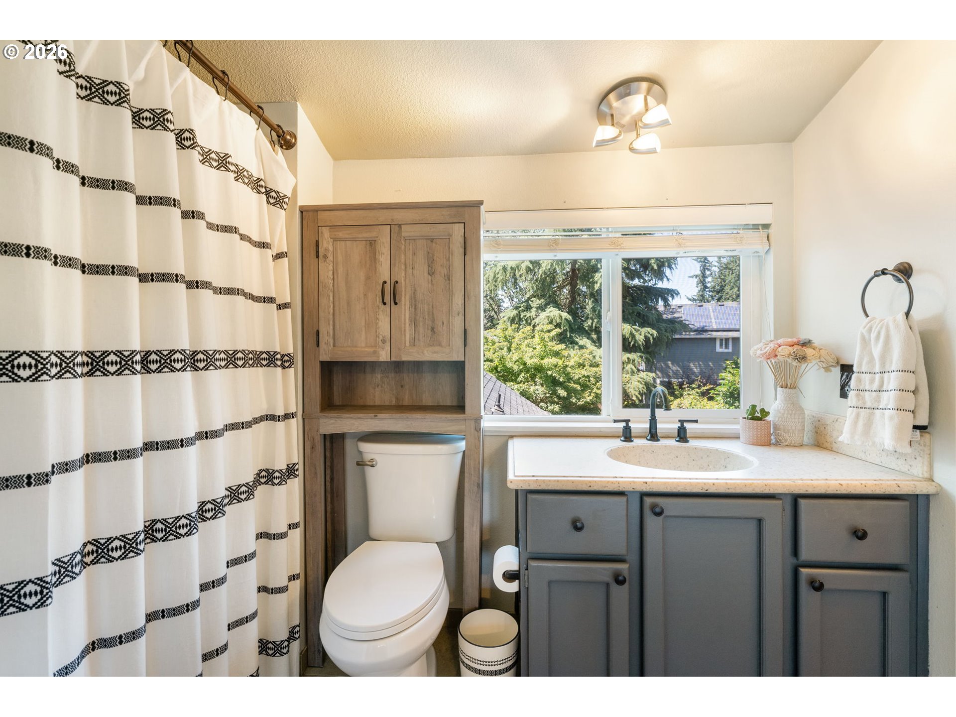 14877 Southwest Oregon Trail Lane Beaverton, OR 97006 - Photo 28 of 41 a bathroom with a sink toilet a mirror and shower