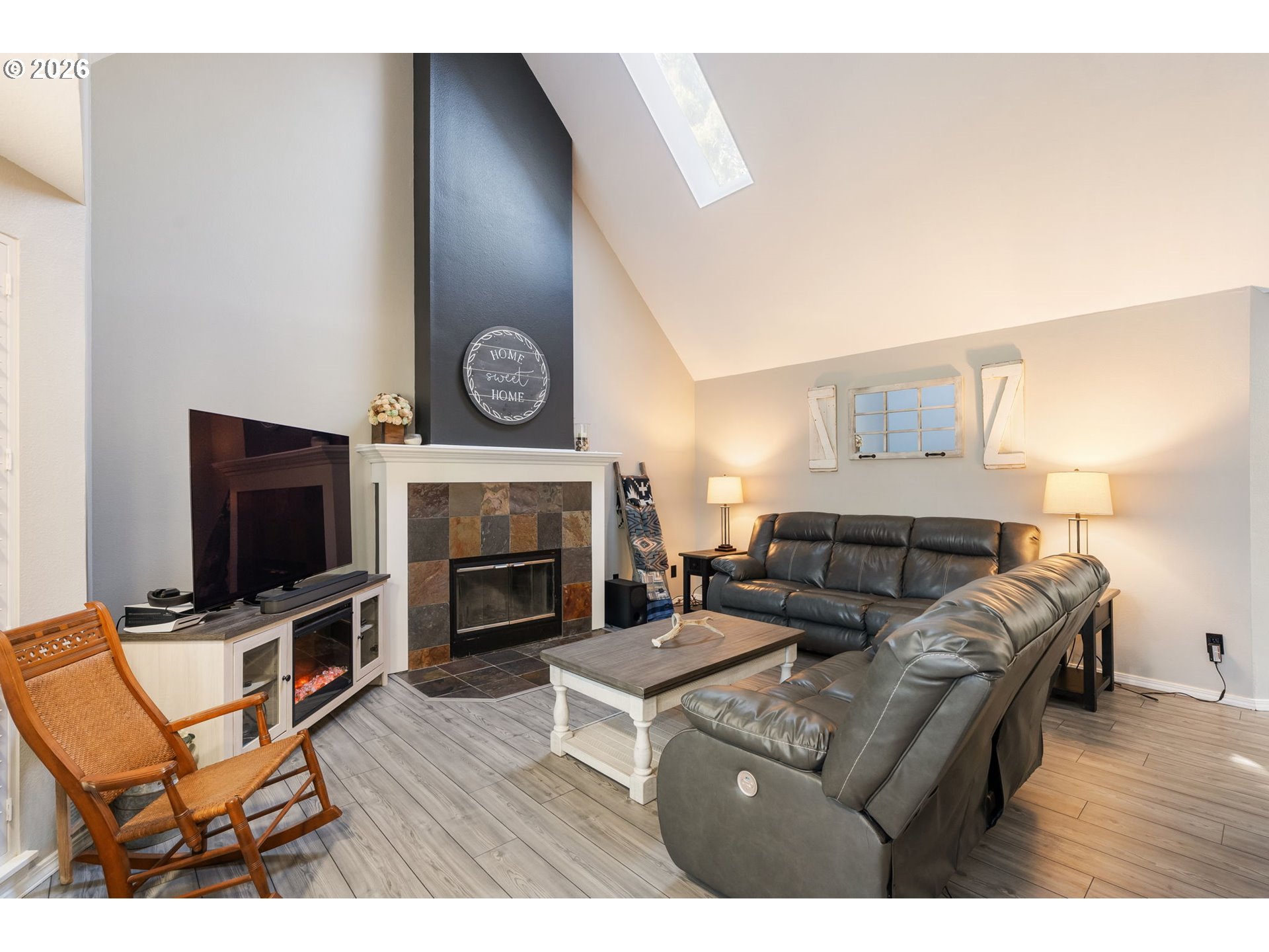 14877 Southwest Oregon Trail Lane Beaverton, OR 97006 - Photo 3 of 41 a living room with furniture a fireplace and a flat screen tv