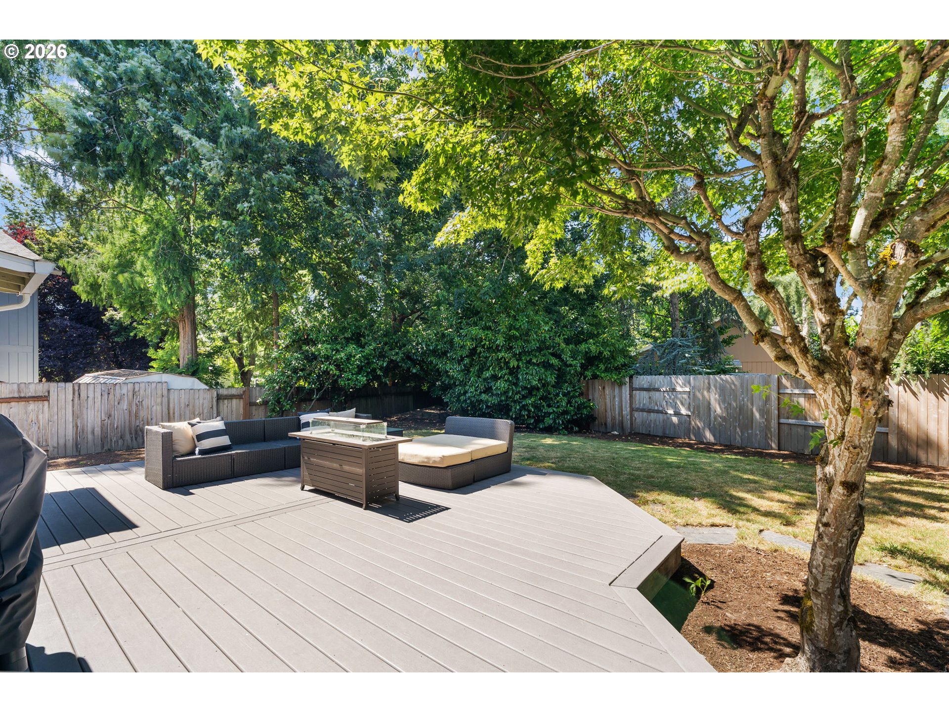 14877 Southwest Oregon Trail Lane Beaverton, OR 97006 - Photo 34 of 41 a backyard of a house with table and chairs