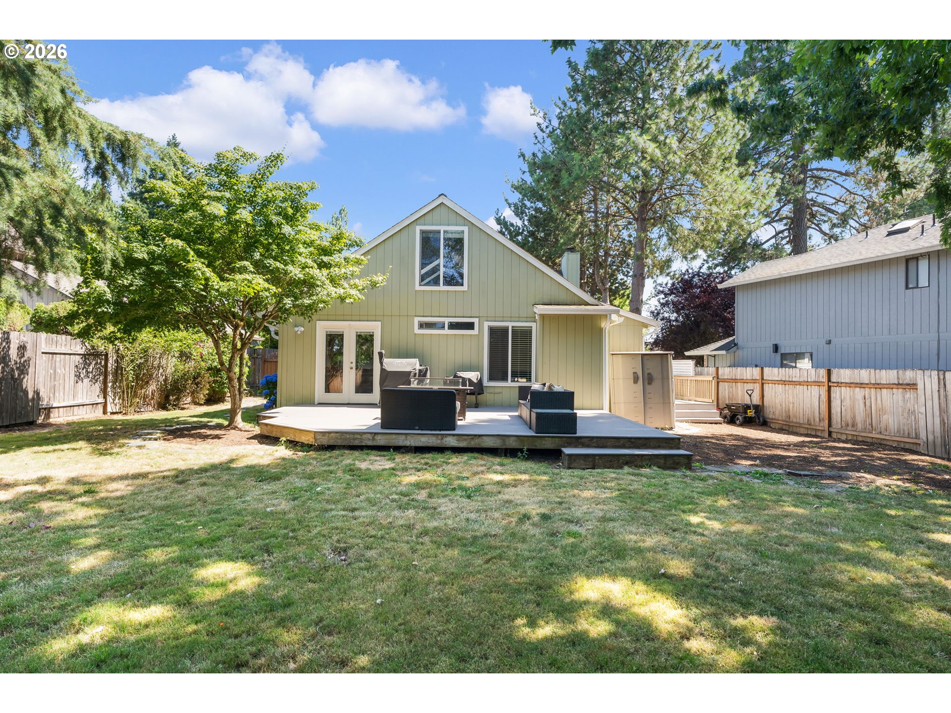 14877 Southwest Oregon Trail Lane Beaverton, OR 97006 - Photo 37 of 41 a front view of a house with a garden and trees
