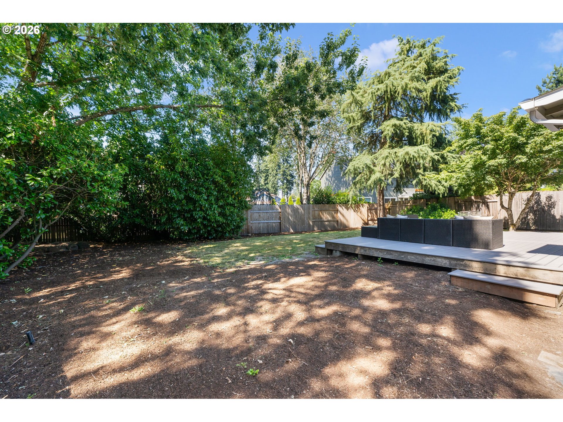 14877 Southwest Oregon Trail Lane Beaverton, OR 97006 - Photo 39 of 41 a view of a yard with plants and wooden fence
