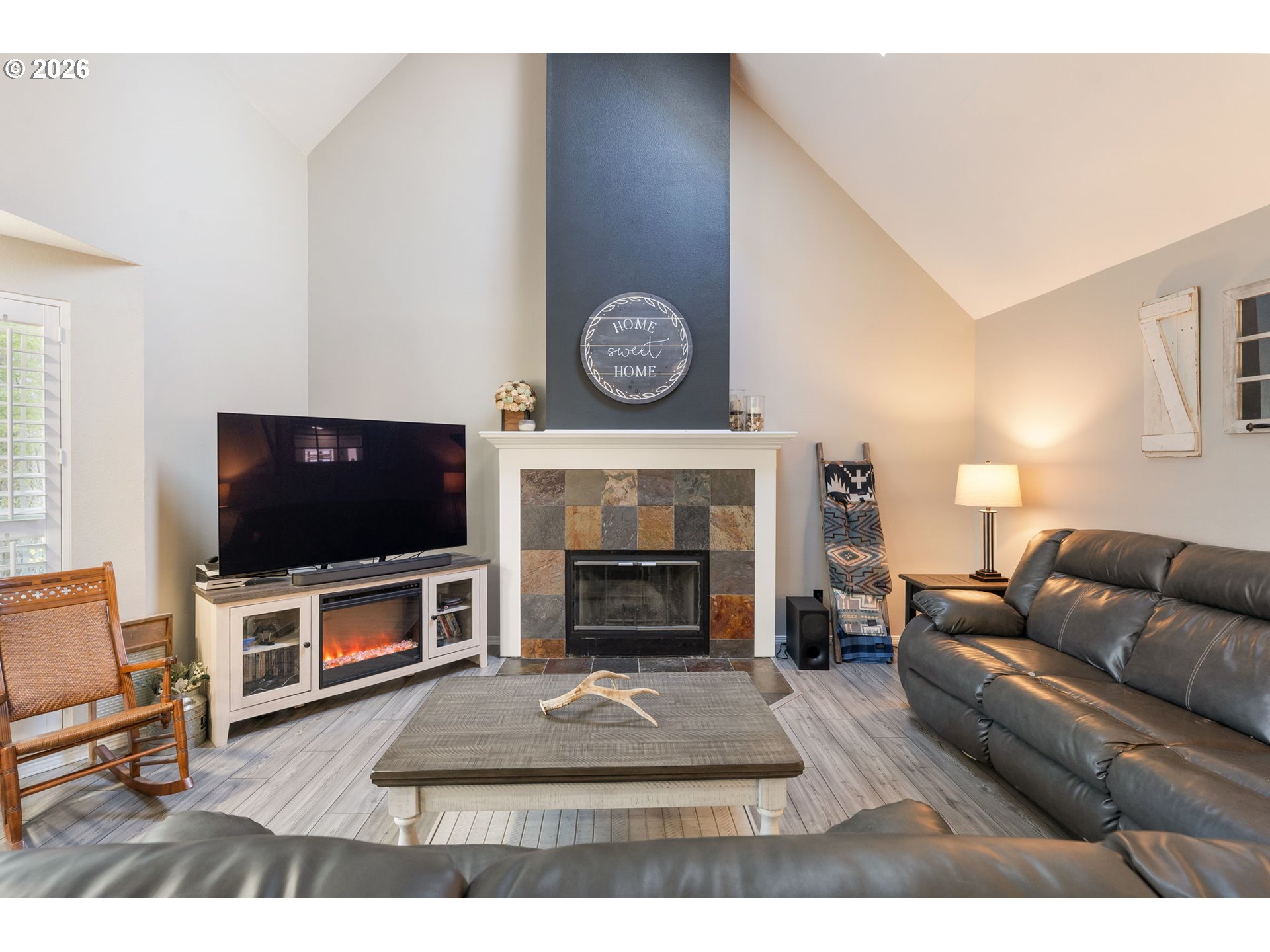 14877 Southwest Oregon Trail Lane Beaverton, OR 97006 - Photo 5 of 41 a living room with furniture a flat screen tv and a fireplace