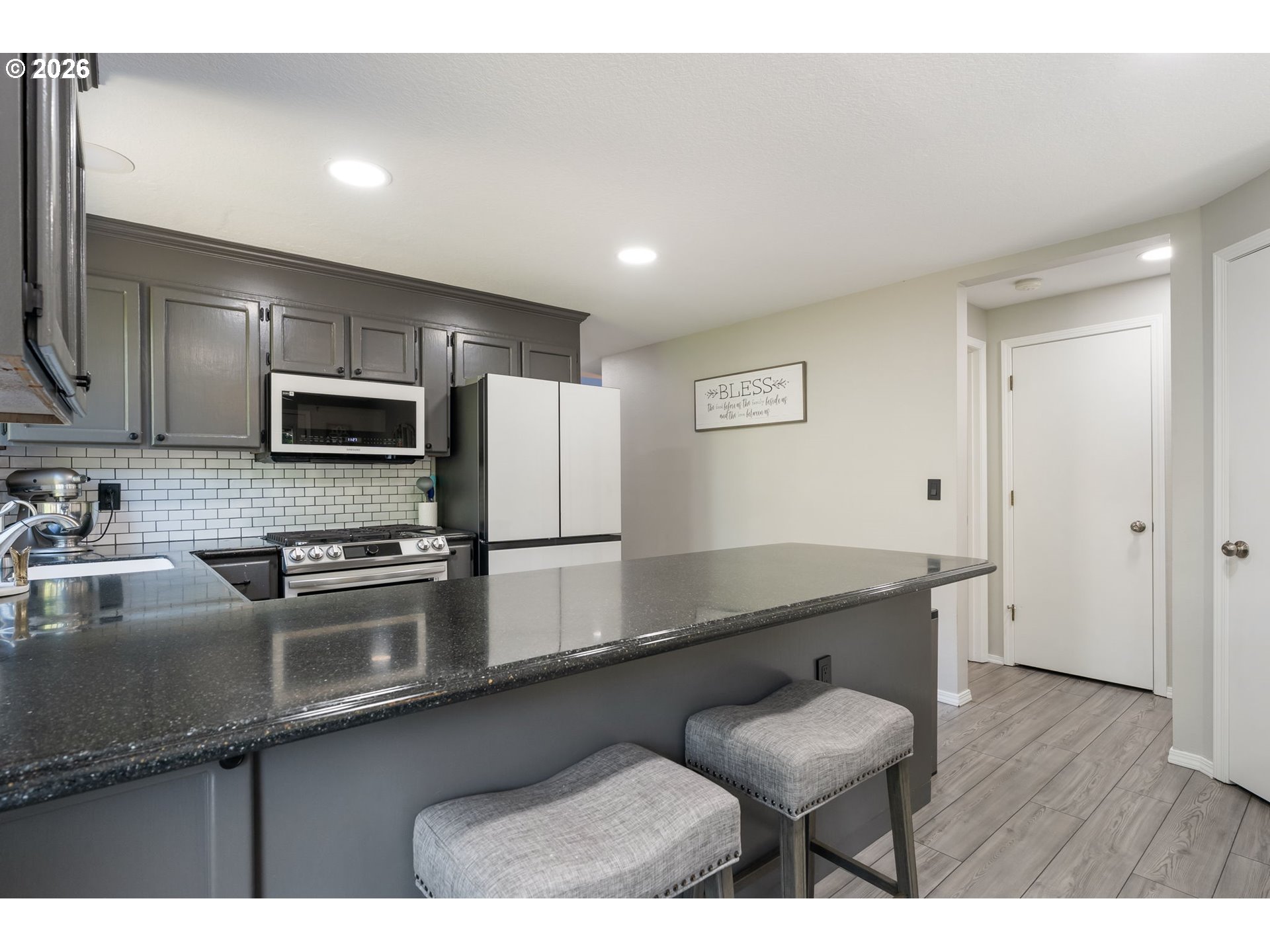 14877 Southwest Oregon Trail Lane Beaverton, OR 97006 - Photo 6 of 41 a kitchen with stainless steel appliances granite countertop a sink counter space and cabinets