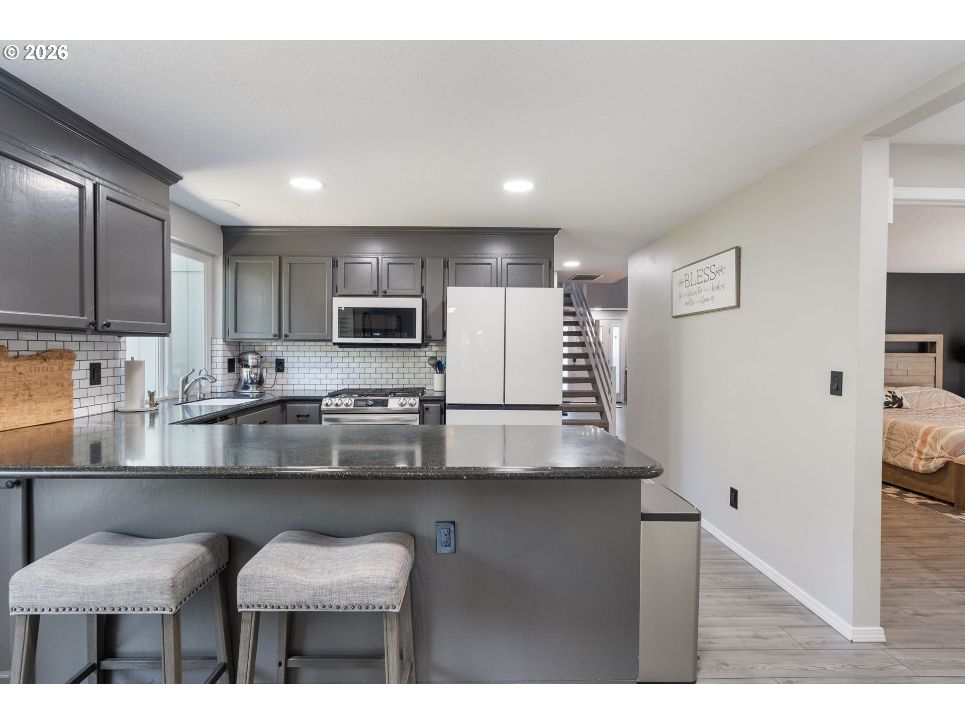 14877 Southwest Oregon Trail Lane Beaverton, OR 97006 - Photo 9 of 41 a kitchen with kitchen island a sink counter top space appliances and cabinets