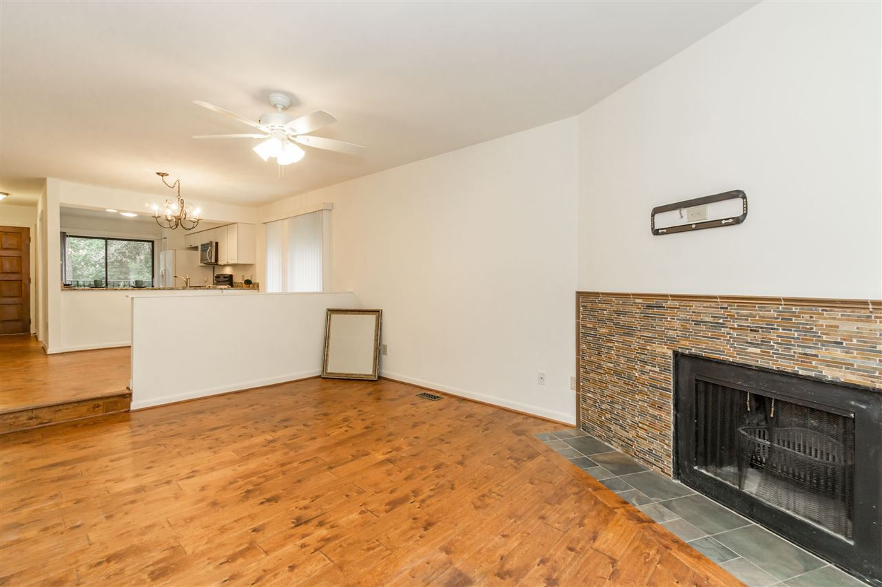 1010 Bend Drive Raleigh, NC 27609 - Photo 11 of 24 Spacious family room features a wood burning fireplace and sliders out to the enclosed patio. Family Room