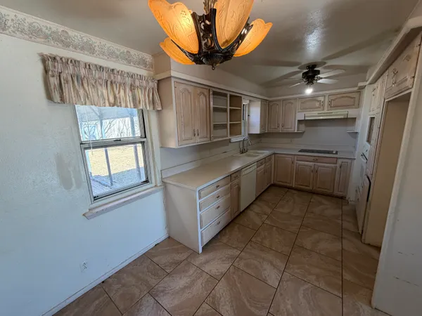 a kitchen with cabinets and window