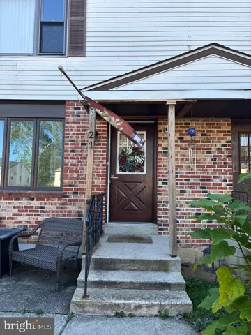 a front view of a house with a garden and patio