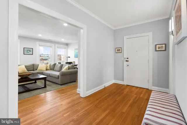 a living room with furniture or couch and a wooden floor