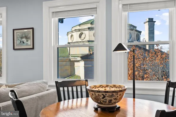 a living room with furniture a fireplace and a large window