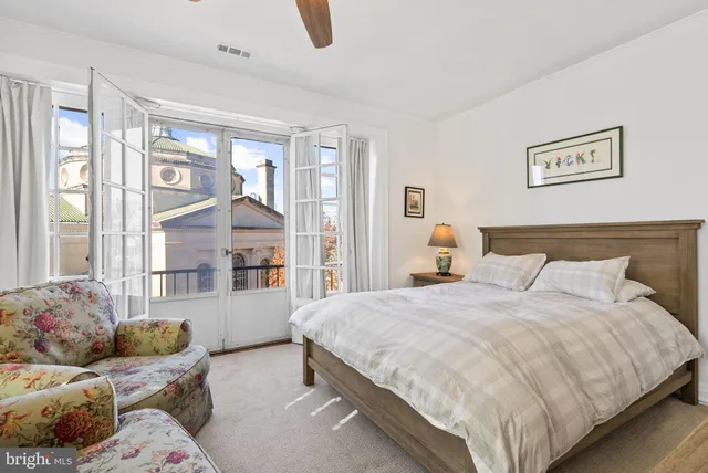 a bedroom with a bed couch and window