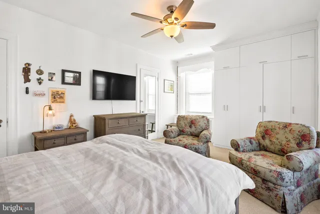 a bedroom with a bed dresser and a window