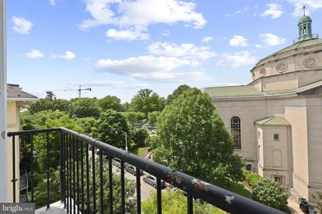 a view of a room with wooden floor and windows