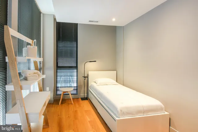 a bedroom with a bed and lamp