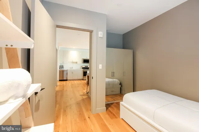 a bedroom with a bed and a desk in it