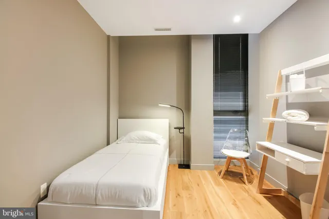 a bedroom with a bed and a lamp