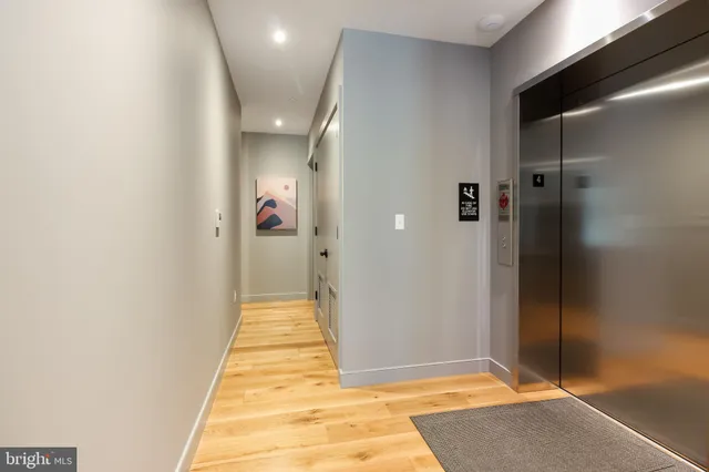 a view of a hallway with wooden floor