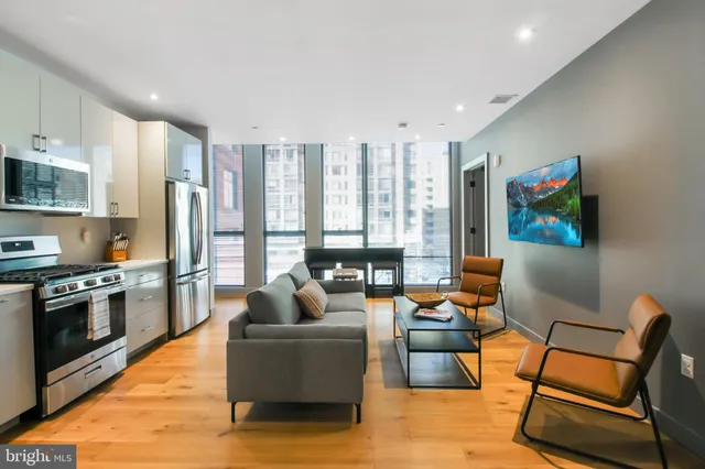 a living room with furniture and kitchen view