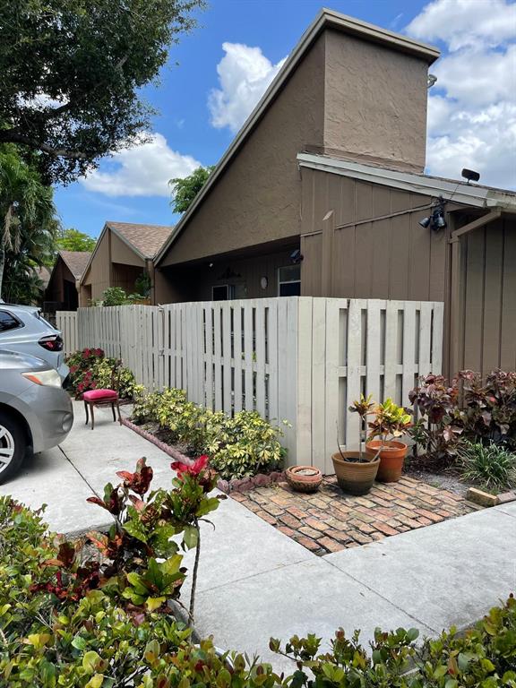 a street view with a chair and table in the patio