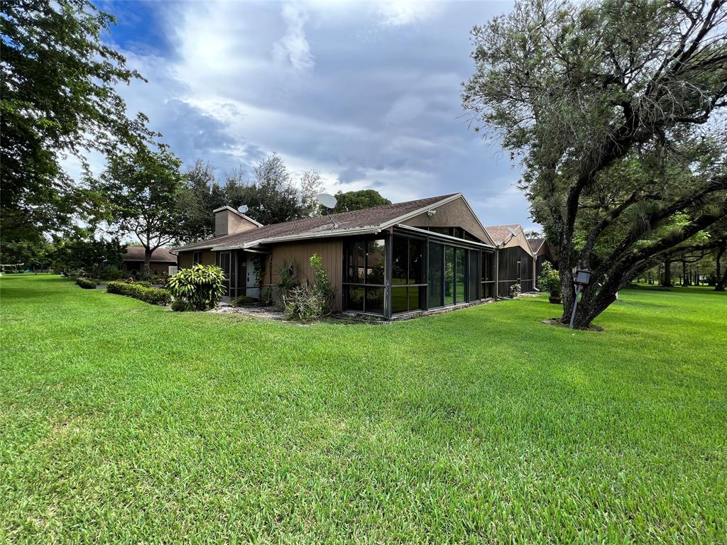 Undisclosed Address Boca Raton, FL 33428 - Photo 2 of 4 a front view of house with yard and green space