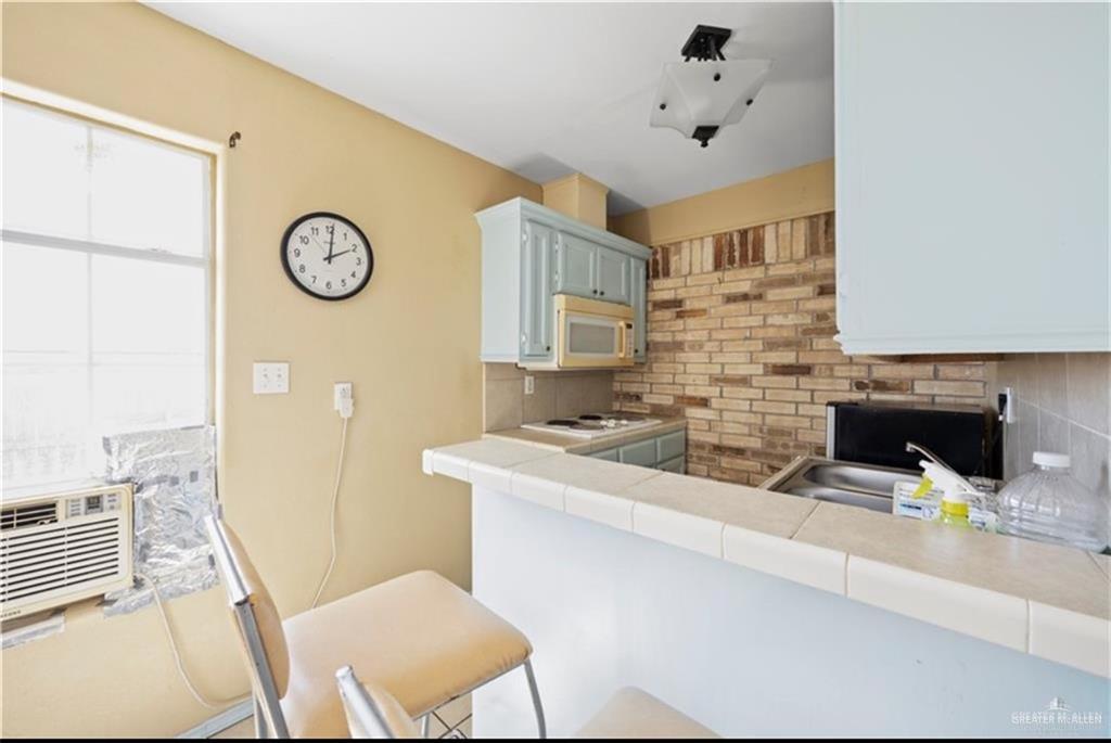 613 South Moorefield Road Mission, TX 78572 - Photo 14 of 19 a living room with stainless steel appliances furniture a fireplace and a open kitchen
