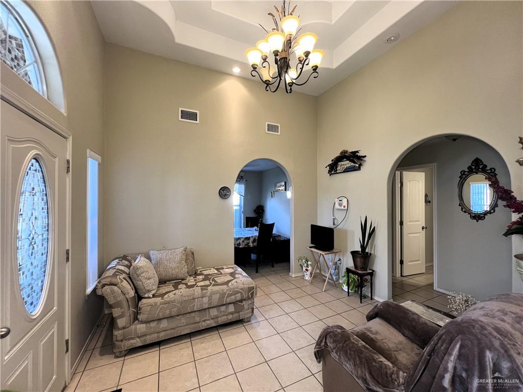 613 South Moorefield Road Mission, TX 78572 - Photo 4 of 19 a living room with furniture a fireplace and chandelier