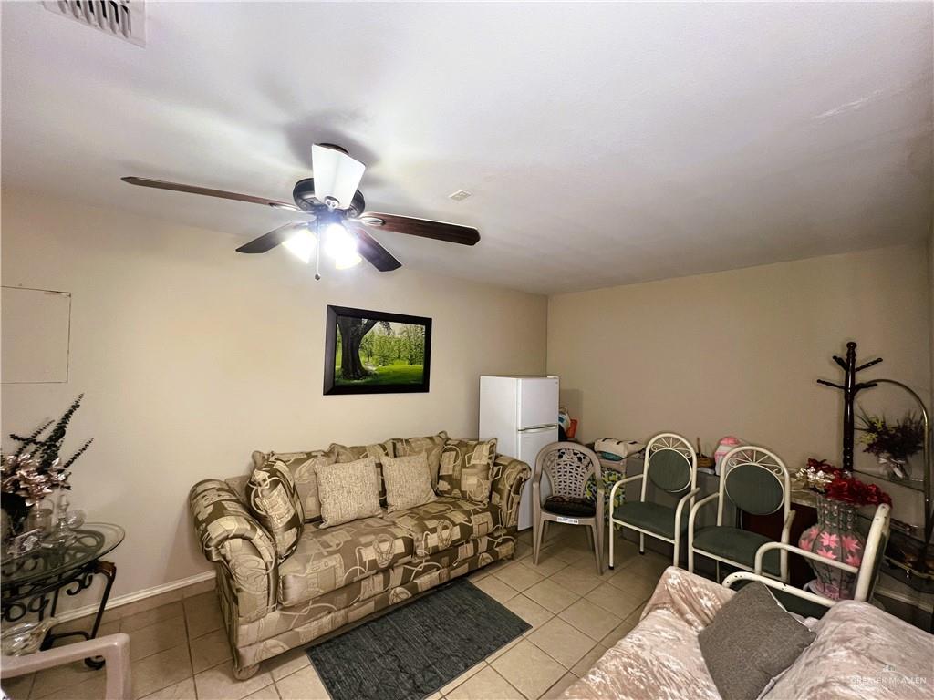 613 South Moorefield Road Mission, TX 78572 - Photo 6 of 19 a living room with furniture a couch and potted plant