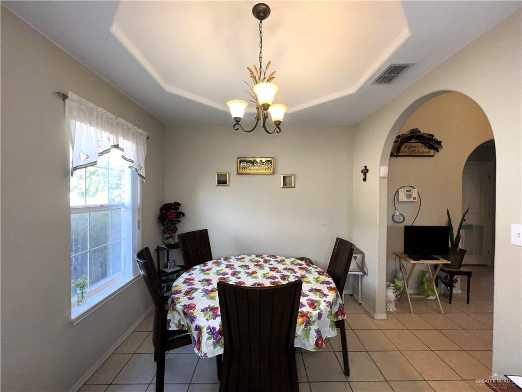 613 South Moorefield Road Mission, TX 78572 - Photo 8 of 19 a view of a dining room with furniture and chandelier