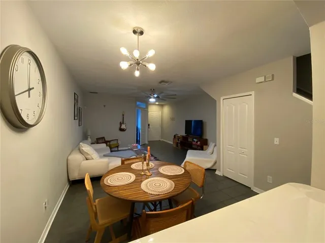 a view of a dining room with furniture and a chandelier