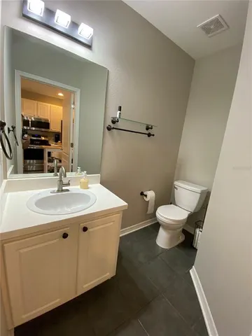a bathroom with a sink toilet and mirror