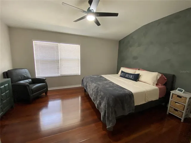 a bedroom with a bed and a couch