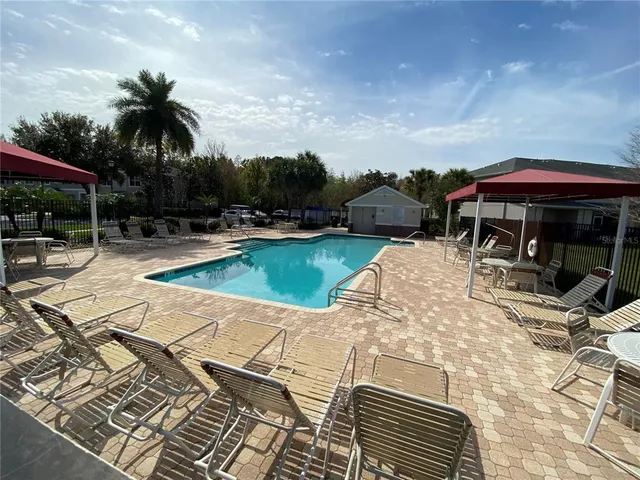 a view of a swimming pool with sitting area